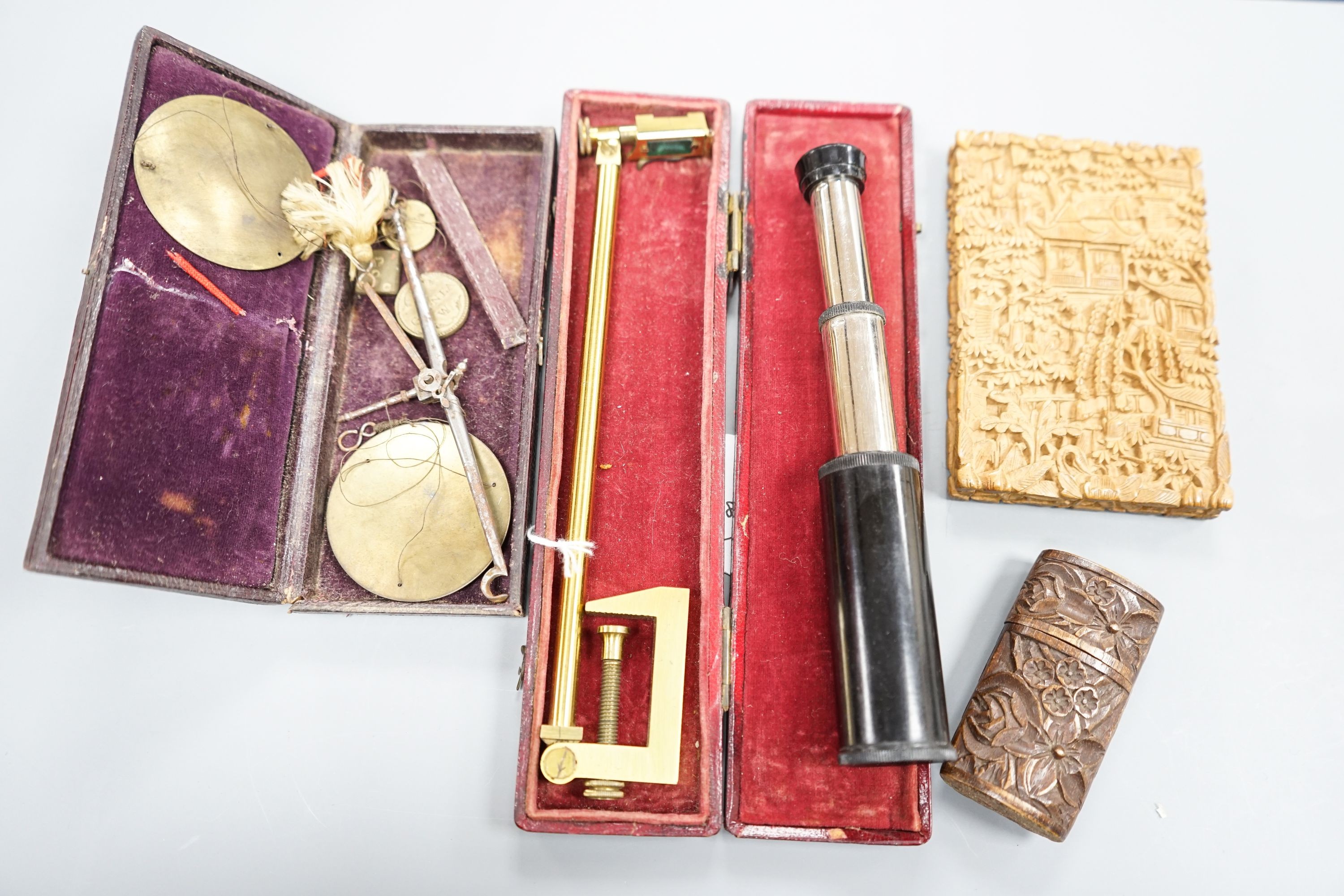 A Chinese carved sandalwood card case, a cased set of Avery gold scales, a Zonex telescope, a cased Cary prismatic instrument and a floral carved wood box.